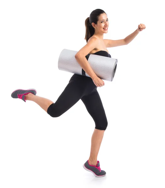 Young woman holding a pilates mat — Stock Photo, Image