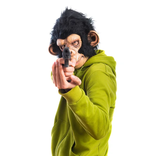 Человек-обезьяна стреляет из пистолета — стоковое фото