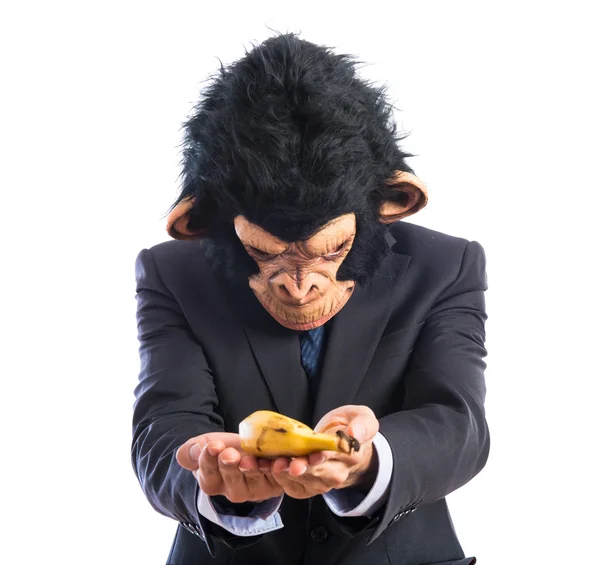 Hombre mono ofreciendo un plátano — Foto de Stock
