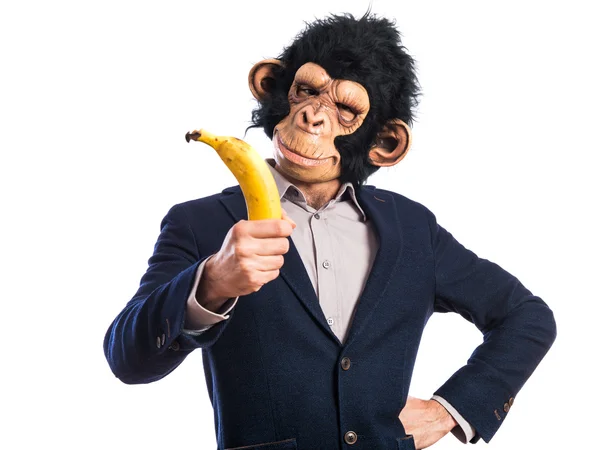 Monkey man innehar en banan — Stockfoto