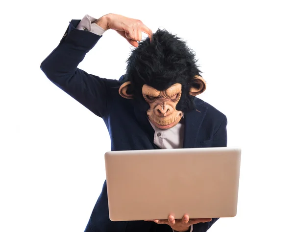 Monkey man having doubts with his laptop — Stock Photo, Image