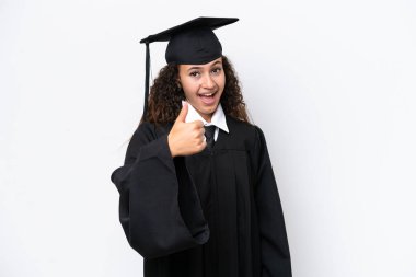 Üniversite mezunu genç bir Arap kadın beyaz arka planda izole edildi. Başparmakları havada, çünkü iyi bir şey oldu.