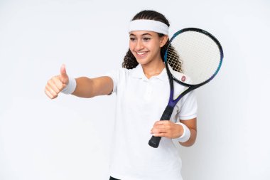 Young tennis player woman isolated on white background giving a thumbs up gesture