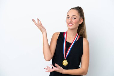 Young caucasian woman with medals isolated on white background extending hands to the side for inviting to come