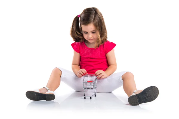 Girl playing with mini supermaeket cart — Stock Photo, Image