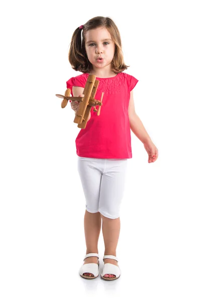 Девушка держит деревянный игрушечный самолет — стоковое фото