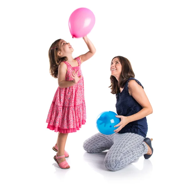 Mother and daughter playing with balloons — Stock Photo, Image