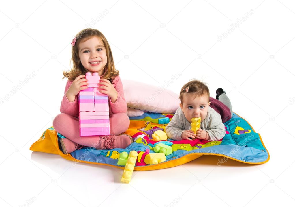 Sisters playing over white background