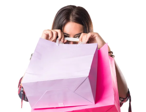 Woman hiding behind shopping bags — Stock Photo, Image