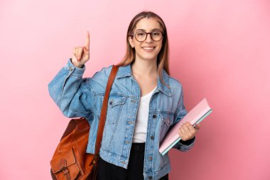 Young caucasian student woman isolated on pink background pointing up a great idea