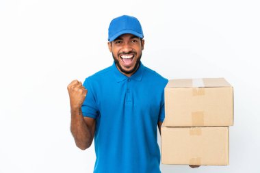 Delivery Ecuadorian man isolated on white background celebrating a victory in winner position