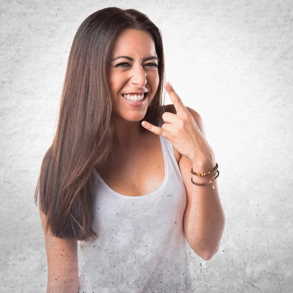 Woman making horn gesture — Stock Photo, Image