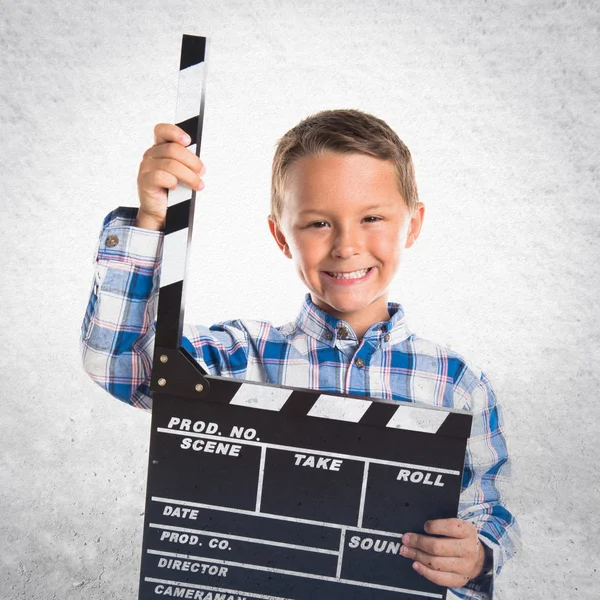 Kid holding a clapperboard — Stock Photo, Image