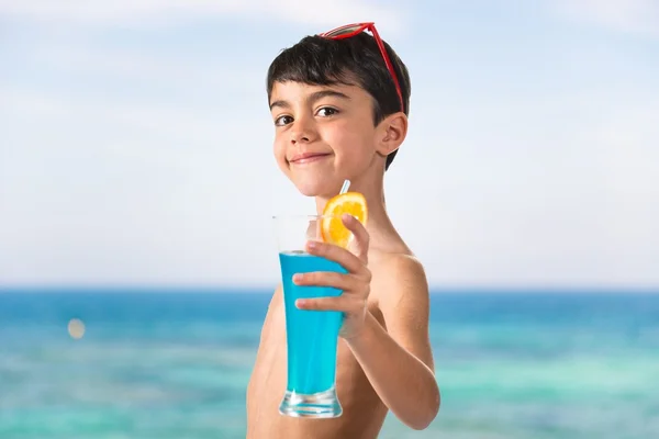 Child holding a blue drink