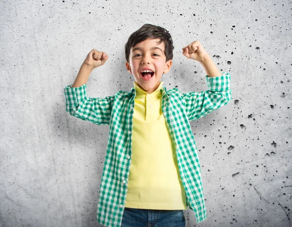 Lucky brunette kid over isolated white background — Stock Photo, Image