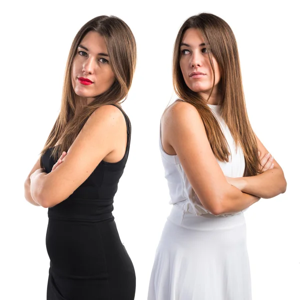 Twin sisters with their arms crossed — Stock Photo, Image
