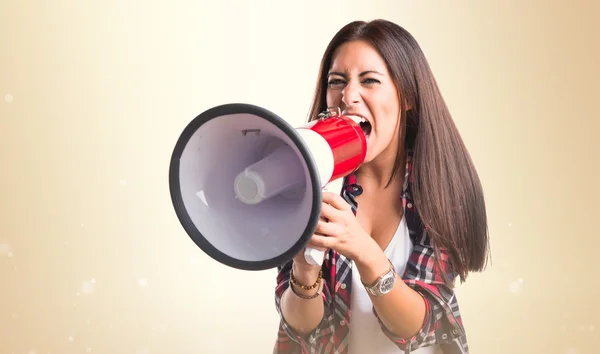 Woman shouting by megaphone — Stock Photo, Image