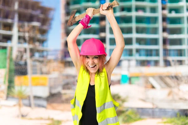 Work woman with ax over white background