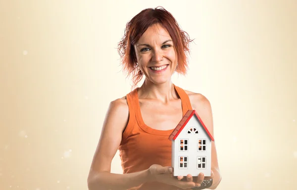 Женщина держит маленький домик — стоковое фото