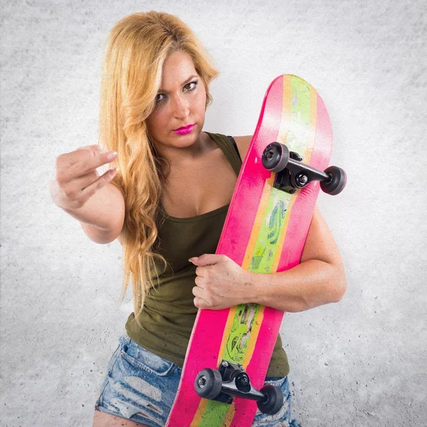 Skateboarder girl making horn gesture — Stock Photo, Image