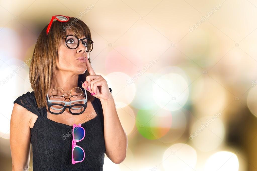 Woman with many glasses thinking something