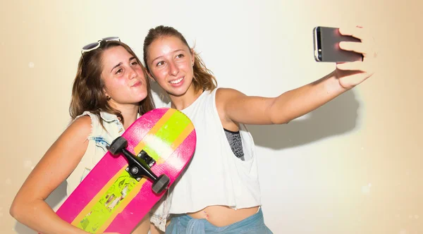 Girls photographing with their skates making a selfie — Stock Photo, Image