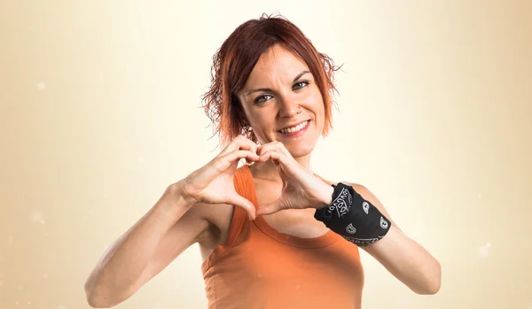 Woman making a heart with her hands — Stock Photo, Image