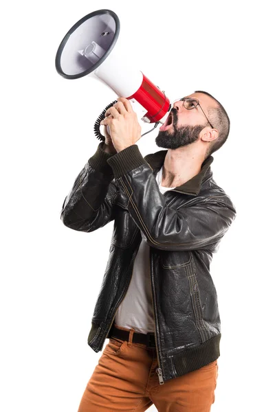 Man wearing a leather jacket shouting by megaphone — Stock Photo, Image