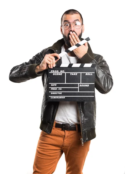 Homem usando uma jaqueta de couro segurando uma clapperboard — Fotografia de Stock