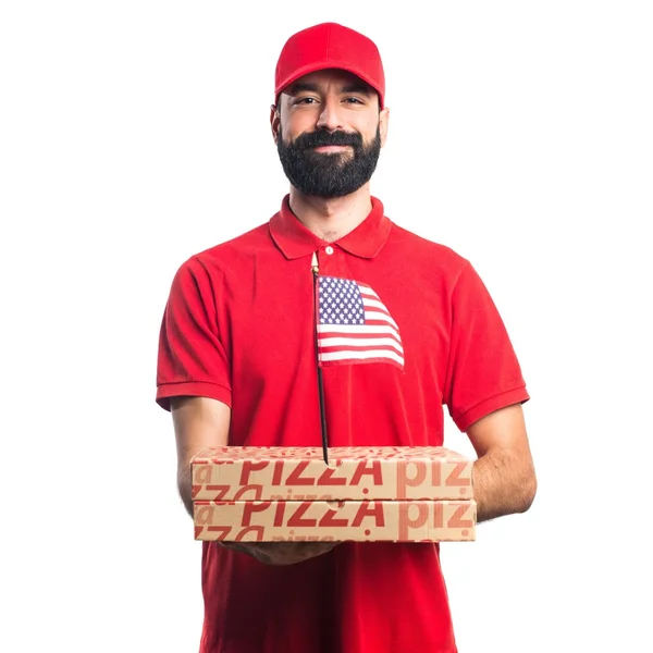 Uomo consegna pizza con una bandiera americana — Foto Stock