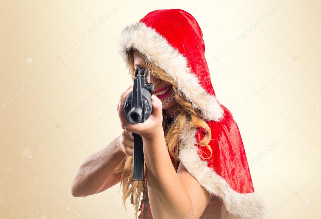 Christmas woman shooting with a pistol