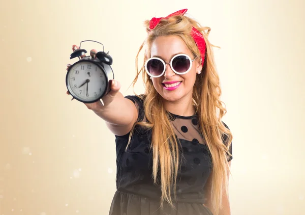 Pin-up girl holding vintage clock — Stock Photo, Image