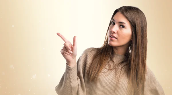 Girl thinking and pointing up — Stock Photo, Image