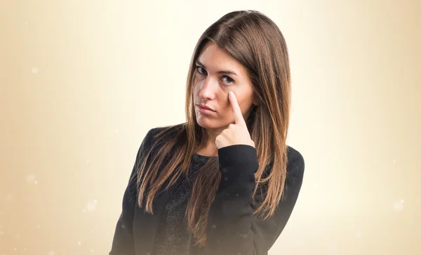 Pretty brunette girl over ocher background — Stock Photo, Image