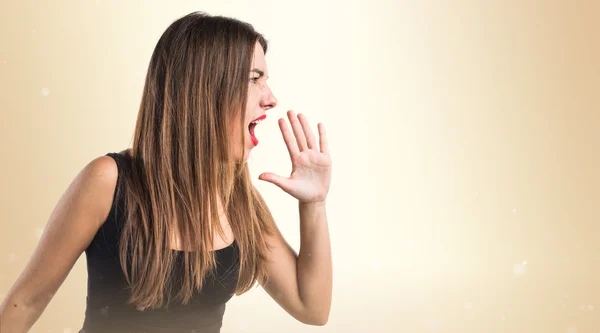 Pretty brunette girl over ocher background — Stock Photo, Image