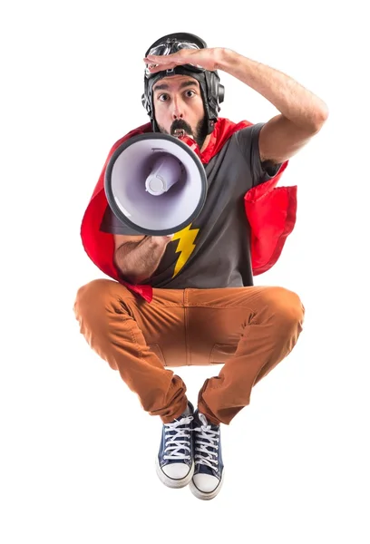 Superhero shouting by megaphone — Stock Photo, Image
