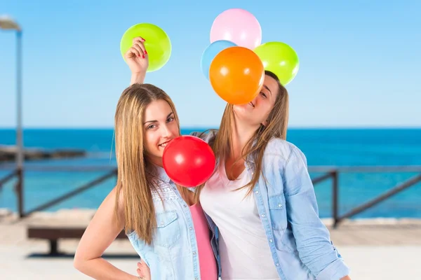 Friends with many balloons over white background — Stock Photo, Image