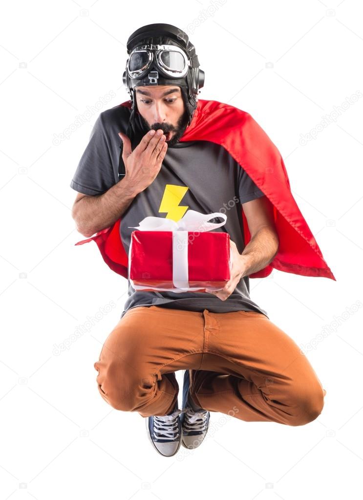 Superhero holding a gift