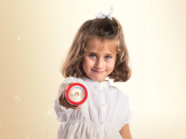 Girl holding a flashlight — Stock Photo, Image