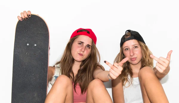 Friends with their skateboards making horn gesture — Stock Photo, Image