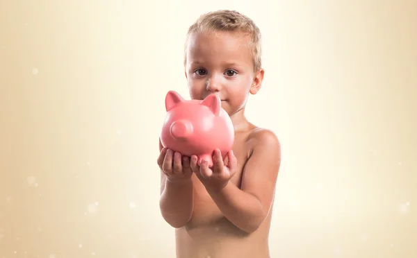Kid holding a piggybank — Stock Photo, Image
