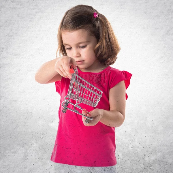 Girl playing with mini supermaeket cart — Stock Photo, Image