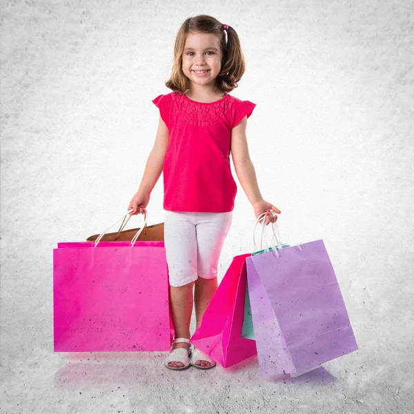 Girl with many shopping bags — Zdjęcie stockowe