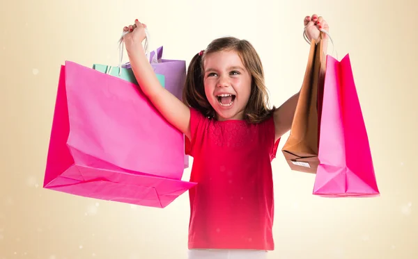 Menina com muitos sacos de compras — Fotografia de Stock