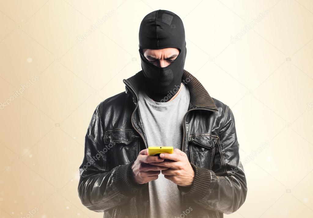 Robber talking to mobile