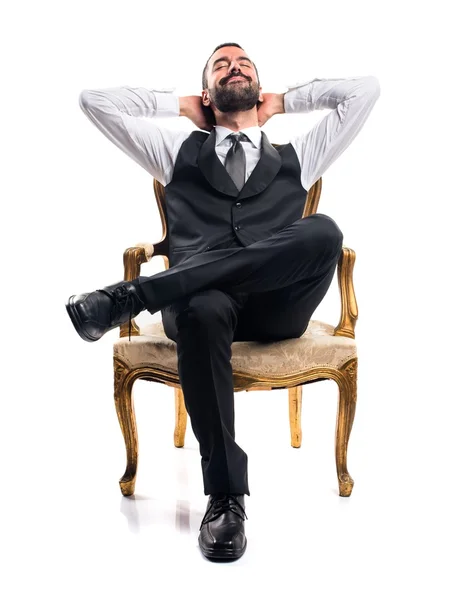 Businessman sitting on armchair Royalty Free Stock Images