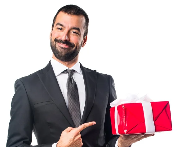 Businessman holding a gift — Stock Photo, Image