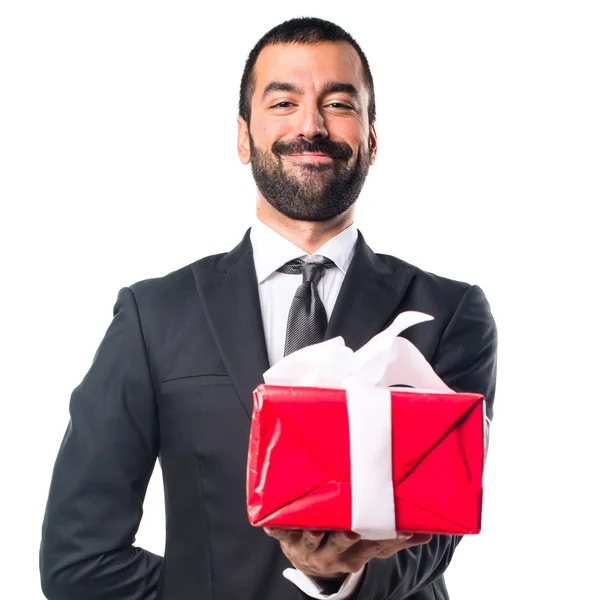 Businessman holding a gift — Stock Photo, Image