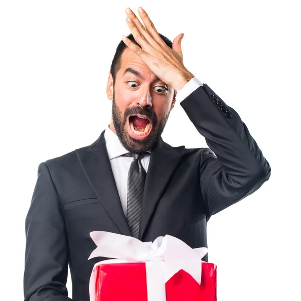 Businessman holding a gift — Stock Photo, Image