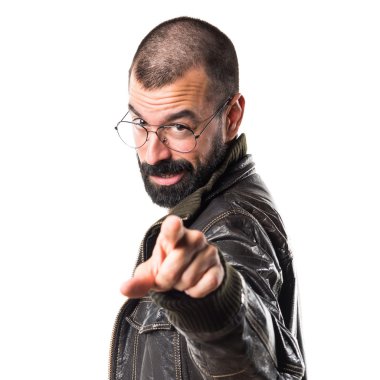 Öne doğru işaret eden bir deri ceket giyen adam